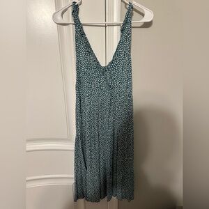 Green dress with little white flowers that goes down to the knee